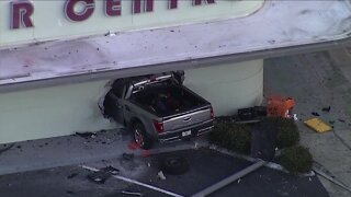 Truck crashes into Lakeland building, partially shutting down road
