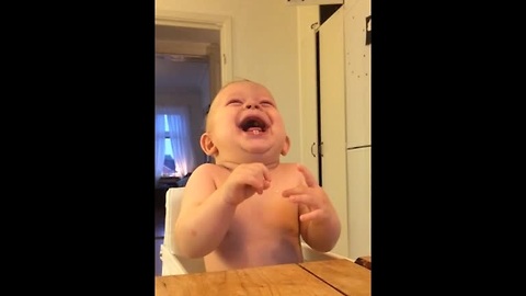 Baby laughing hysterically at coconut