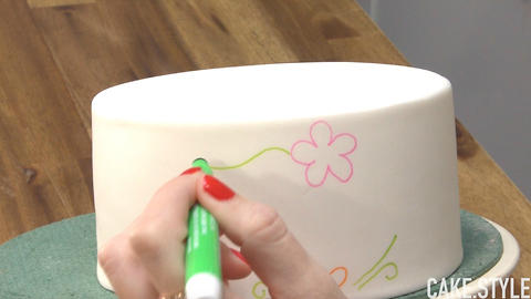 She draws on a cake, but it's not what you think..