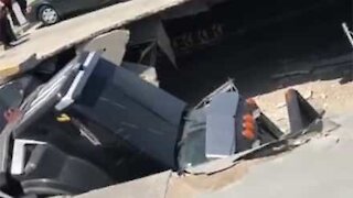 Garbage truck trashes mall after parking lot collapses