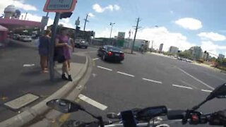 Motorcyclist distracted by group of attractive women