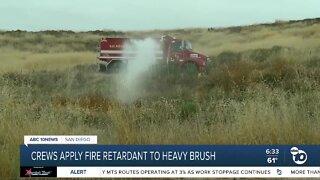 County fire crews spray heavy brush