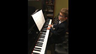 Gifted child plays O Holy Night