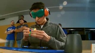 Guy solves Rubik's cube blindfolded!