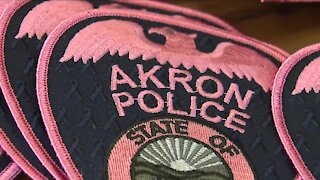 Akron police officers wearing pink patches for breast cancer awareness month