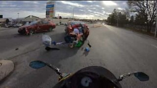 Cars collide right in front of motorcyclist