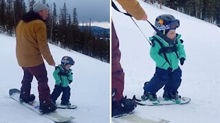 Sleepy boy takes a quick nap during snowboarding lessons
