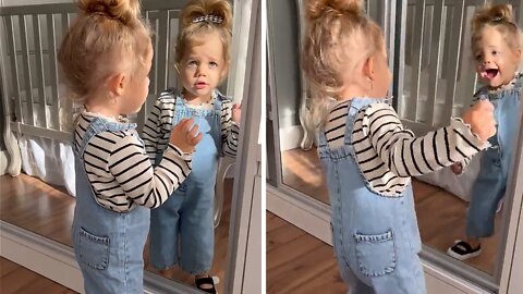 Toddler adorably dances in front of a mirror