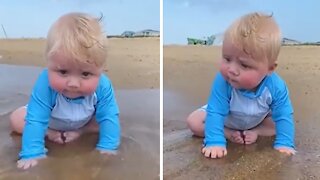 Cute little baby boy enjoys a day at the beach