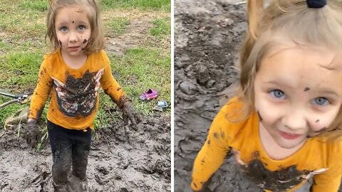 Little girl has the time of her life playing in the mud