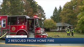 North Royalton firefighters rescue 2 people, dog from house fire