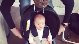 Clever father stops baby from crying by pretending car seat is a robot