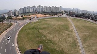 Incredible moment paraglider accidentally lands in roundabout