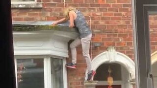 Woman falls trying to climb through a window