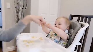 Mom fist bumping with baby causes hilarious giggle fit