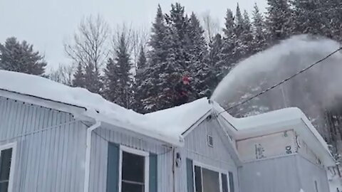 Clever cottage owner snow blows four feet of snow from rooftop