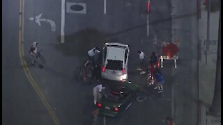 Car drives through protesters in LA