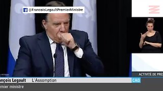 François Legault tousse dans sa main pendant sa conférence de presse et le regrette vite