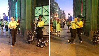 HEARTWARMING FOOTAGE SHOWS ELDERLY GENTLEMAN DANCING IN STREET ALONG WITH BUSKER
