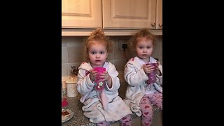 Cute little girls enjoy their morning tea