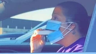 Woman finds a way to eat while wearing mask