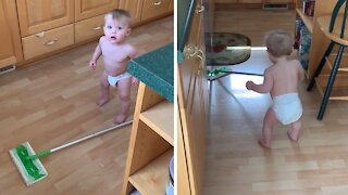 Adorable baby helps clean around the house