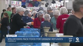 Volunteers pack food for refugees