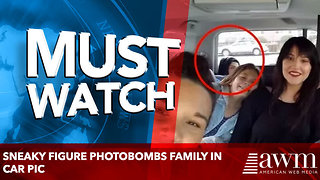 Sneaky Figure Photobombs Family in Car Pic