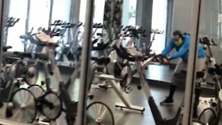 Man doesn't know how to use exercise bike