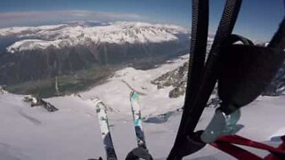 Brave skier performs awesome parachute jump