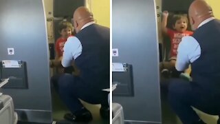 Compassionate flight attendant plays with little kid before takeoff