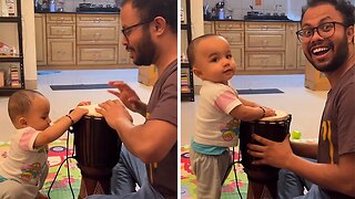Baby plays the drums after seeing dad do it