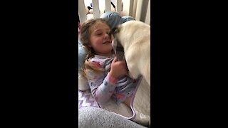 Little girl wakes up to playtime with her doggy