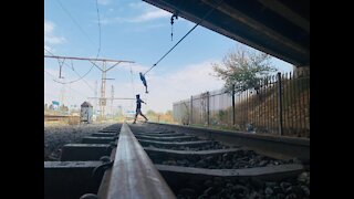 Young boys playing with railway cables