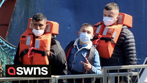 Migrants arrive in Dover after being picked them up from the English Channel