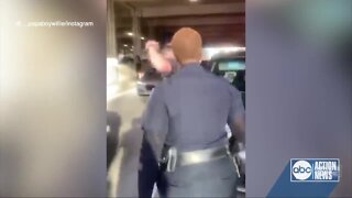 Officer suspended after being caught on video pushing kneeling woman