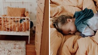 Adorable toddler fakes sleeping after being caught
