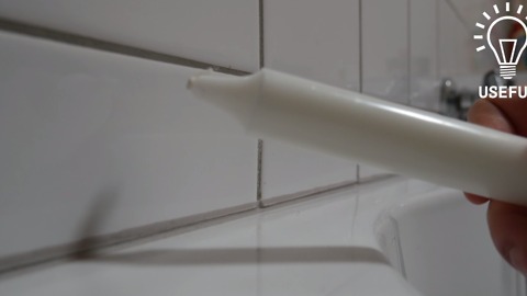 He rubs a white candle on his bathroom tiles. The reason is brilliant!