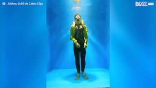 Guy holds his breath to dance underwater