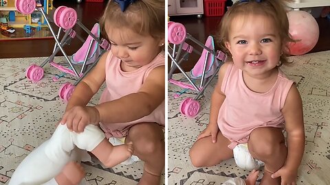 Little girl hilariously gags while changing doll's diaper