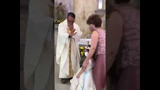 Funny kid thinks the priest wants a high five