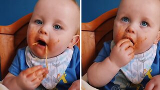 Baby gets totally messy eating spaghetti with his hands