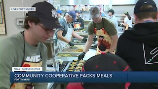 Community Cooperative packing meals this Thanksgiving