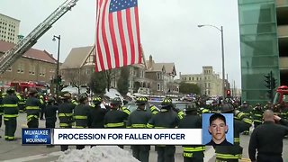 Fallen officer carried to Medical Examiner in police procession