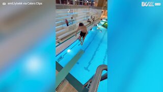Guy makes incredible leap into pool after jumping between diving boards