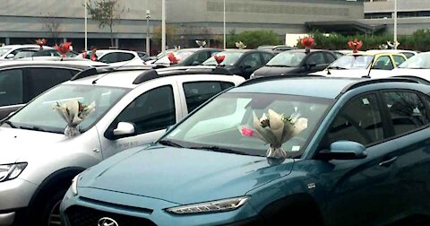 Florist Places Bouquets On Every Car In A Hospital Parking