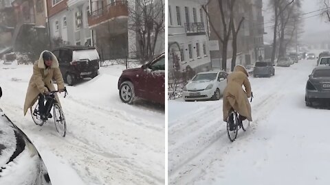 Dude prefers to ride his bike through the heavy snow