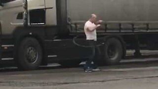 Truck driver does hula hoop as exercise routine