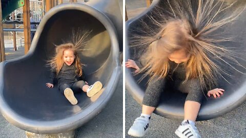 Slide's static electricity causes little girl to have insane hairstyle