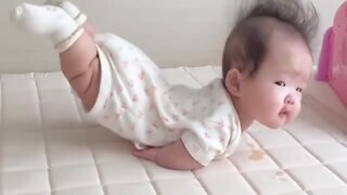 Toddler hilariously lays with her legs in the air